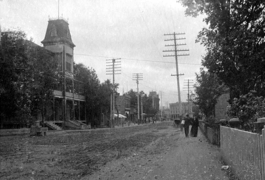 Paysage urbain à Granby. Plusieurs poteaux électriques s'élèvent de part et d'autre de la rue Principale.